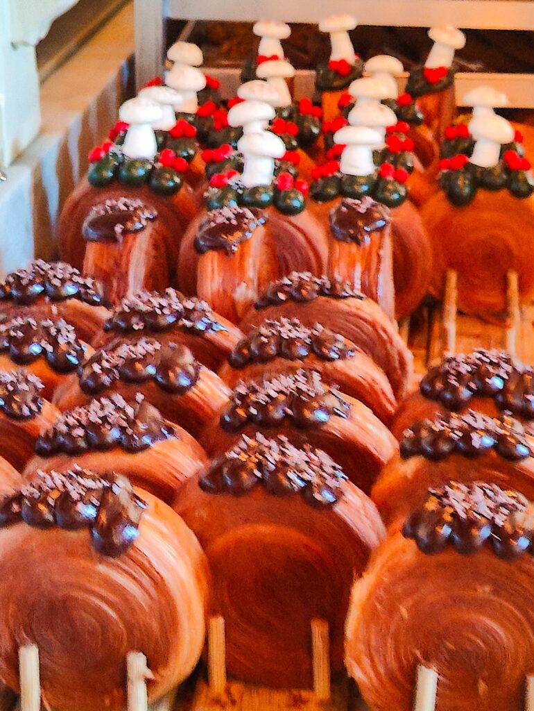 A view of a variety of different croissants with chocolate on top. 