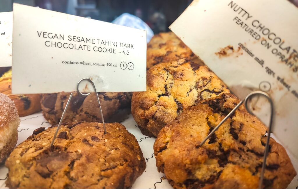 A view of the delicious chocolate chip cookies with name tags behind a glass case at Mamam in NYC. 