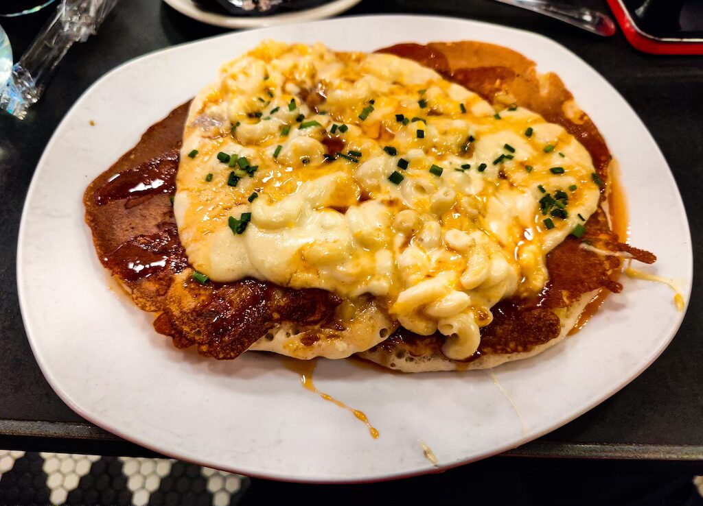 Aerial view of pancakes with maple syrup and mac and cheese from Mom's.